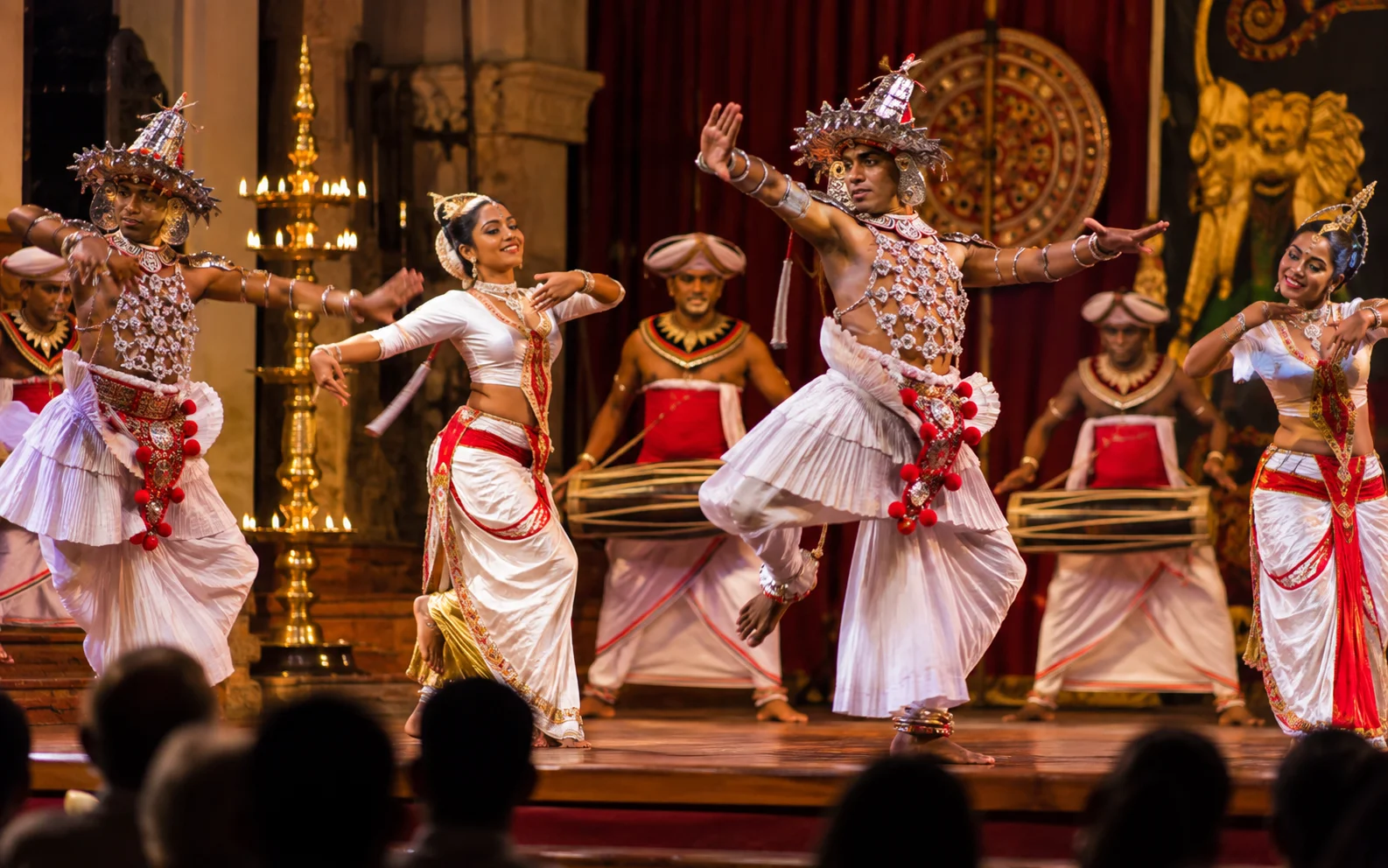Traditional Kandyan dancers and drummers performing in colourful ceremonial costumes in Kandy